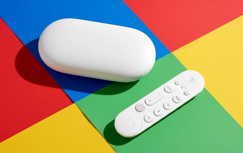 TechDogs-"Gemini Arrives On The Google TV Streamer"-"Google TV Streaming Device And Remote Placed On A Colorful Google-Themed Background" TechDogs-"Gemini Arrives On The Google TV Streamer"-"Google TV Streaming Device And Remote Placed On A Colorful Google-Themed Background"