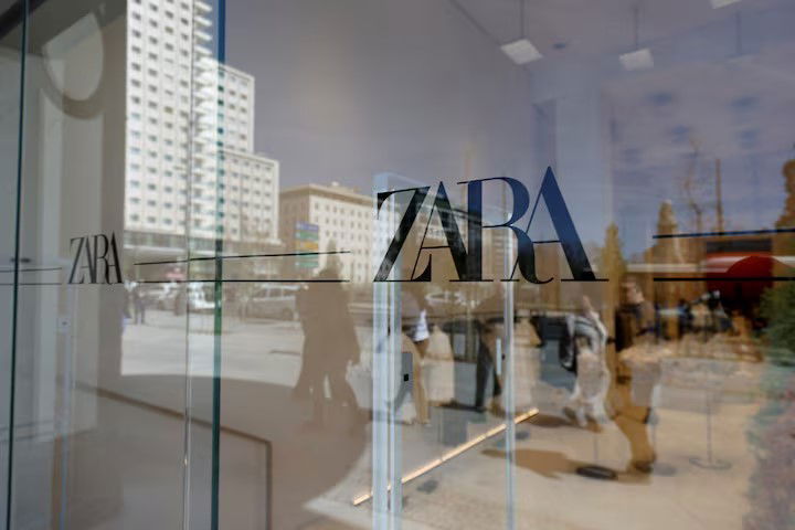 TechDogs-"What Is Zara Doing With AI Fashion Imagery?-"Zara Storefront With Logo Visible Through Glass, Reflecting Pedestrians Outside A Flagship Retail Store In An Urban Setting"