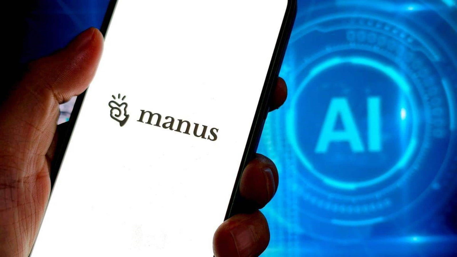 TechDogs-"Meta Acquires AI Startup Manus in $2 Billion Deal"-"An Image Showing A Person Holding A Smartphone With Manus Logo And AI Displayed In The Background"