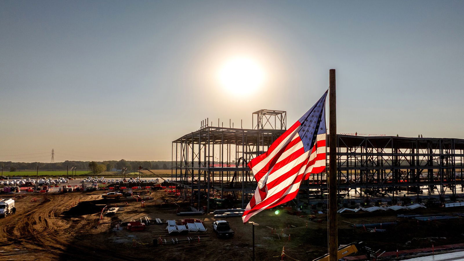TechDogs-"An Image Of An Amazon Data Center Being Constructed With A US Flag In Focus"