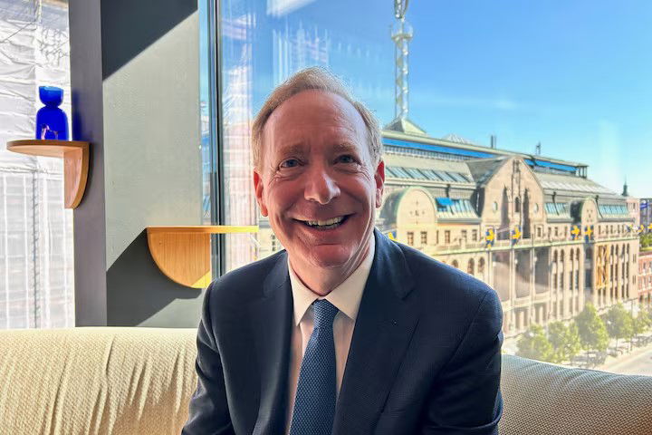 TechDogs-"Brad Smith Highlighting AI Deepfake Risks In Context Of Abusive Content Concerns"