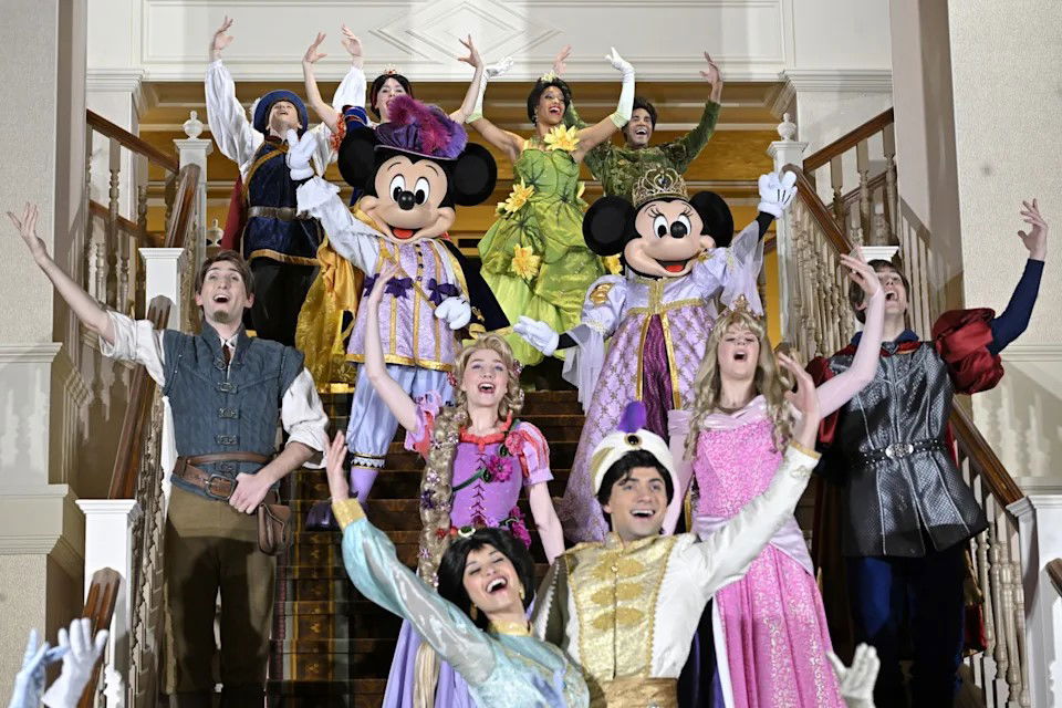 TechDogs-"Hollywood Meets AI: OpenAI’s Disney Deal Paid In Equity"-"Disney Performers And Mascots Including Mickey And Minnie Mouse Celebrating On Stage With Classic Fairytale Characters"