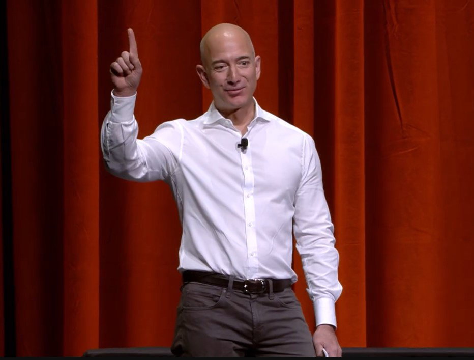 TechDogs-"Step-By-Step Customer Journey Mapping Process"-"Jeff Bezos Speaking Onstage Pointing Upward While Discussing Customer Obsession And Leadership Principles"