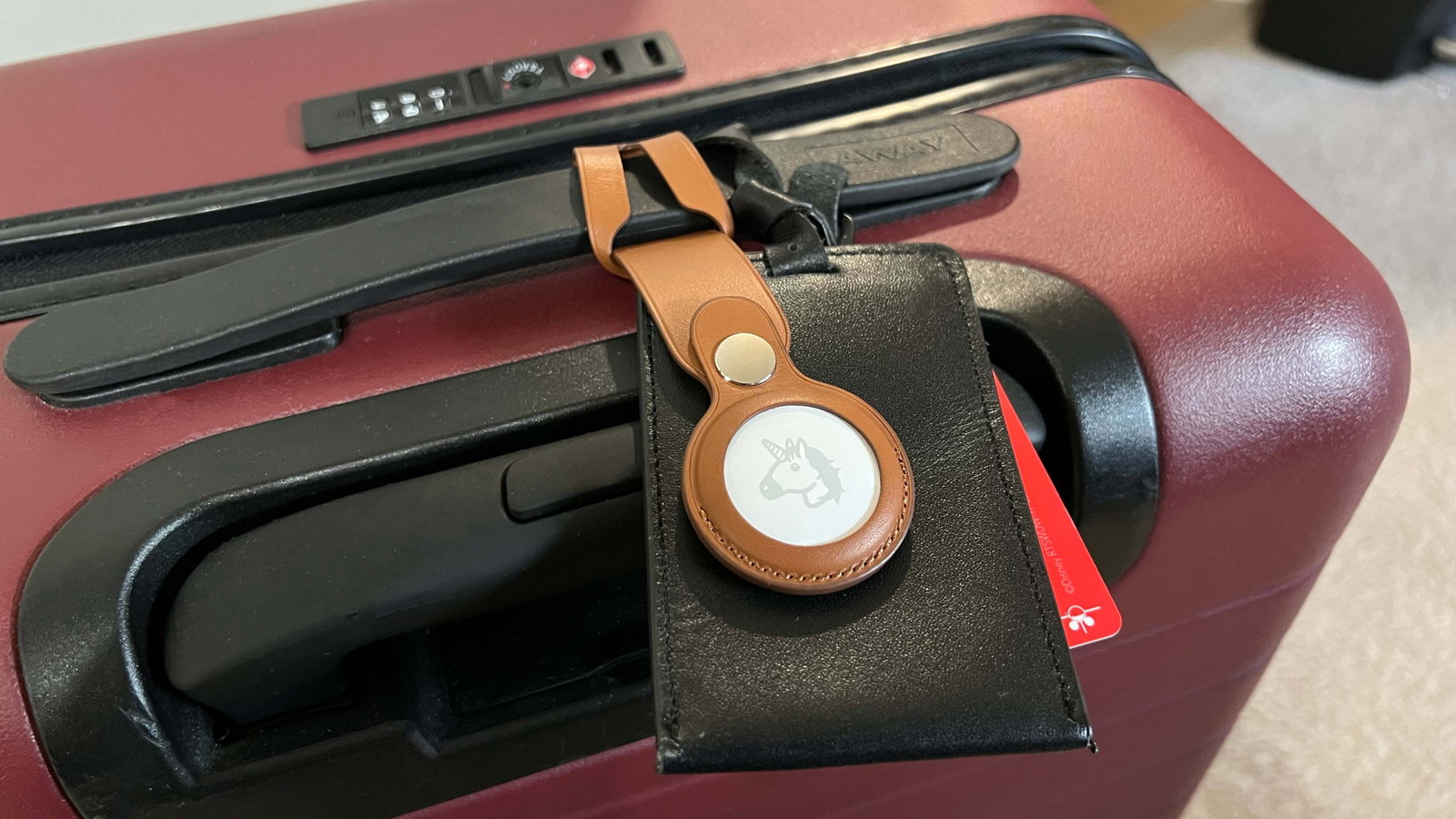 TechDogs-"Smart Luggage Tags And Trackers"-"An Image Of An Apple AirTag On A Suitcase"