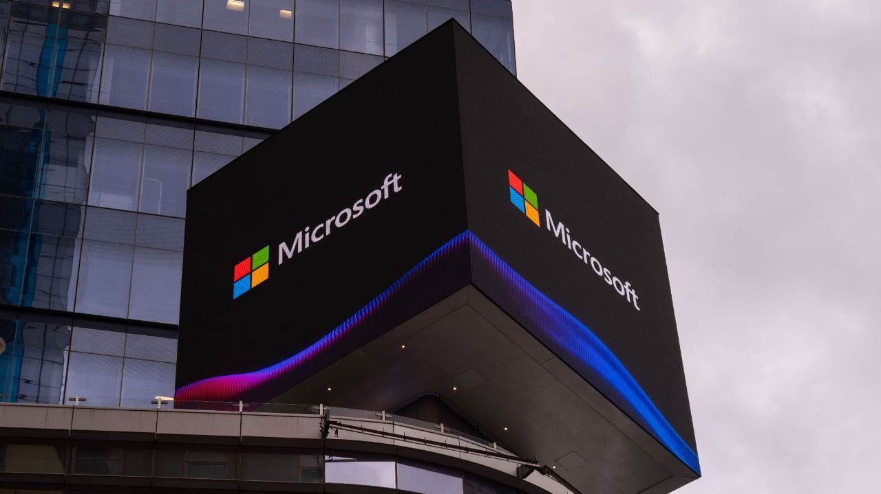 TechDogs-"Microsoft Signs Billion-Dollar Contract With IREN For Nvidia Chips"-"An Image Of A Digital Billboard With A Microsoft Logo Displaying On It"