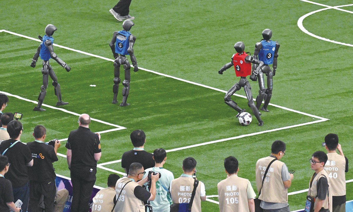 TechDogs-"The Fails Of World Humanoid Robot Games 2026"-"An Image Of Robots Playing Football At The World Humanoid Robot Games 2026"
