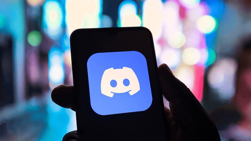TechDogs-"What Really Happened In The Discord Data Breach?"-"An Image Of A Hand Holding A Mobile With Discord Logo On Screen"