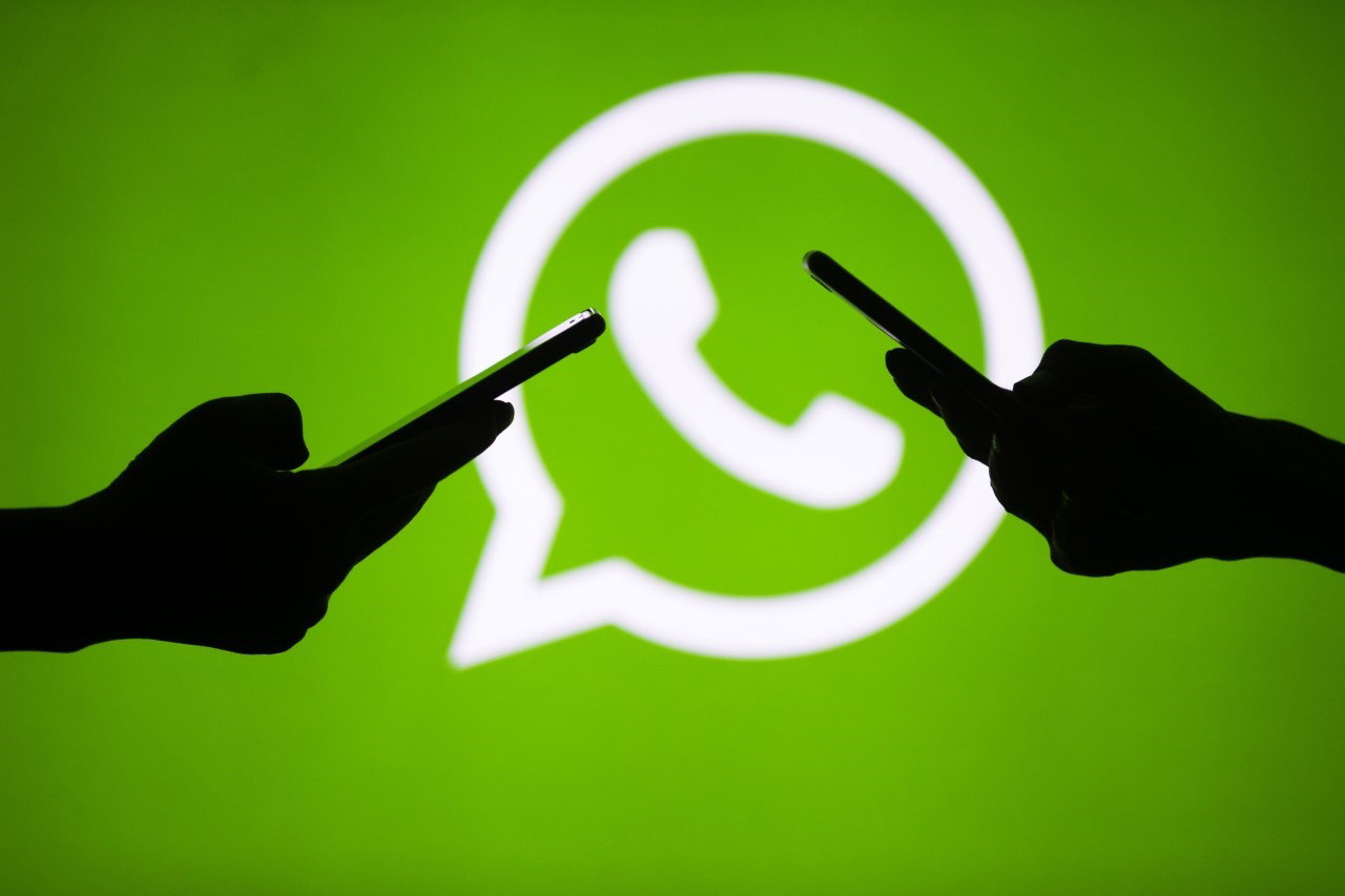 TechDogs-"Italy Pushes Back On Meta’s Control Of AI Distribution"-"An Image Showing 2 People Holding Smartphones With WhatsApp Logo In The Background"