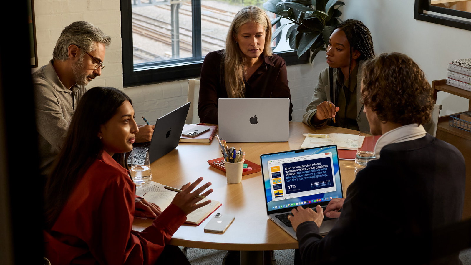 TechDogs-"An Image Depicting Professionals Using Apple's MacBook Pro"