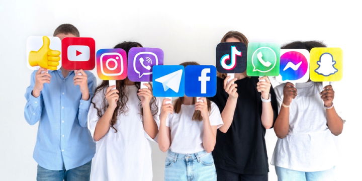 TechDogs - "An Image Showing Teenagers With Social Media Icon Banners"