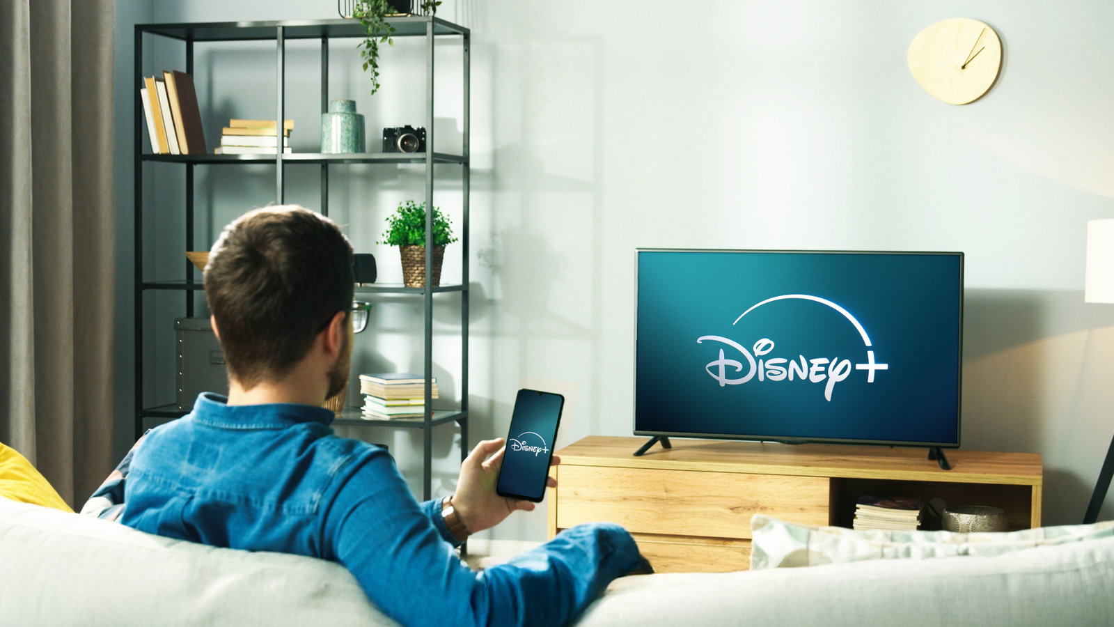 TechDogs-"An Image Of A Person Watching Disney+ On His Phone And TV"