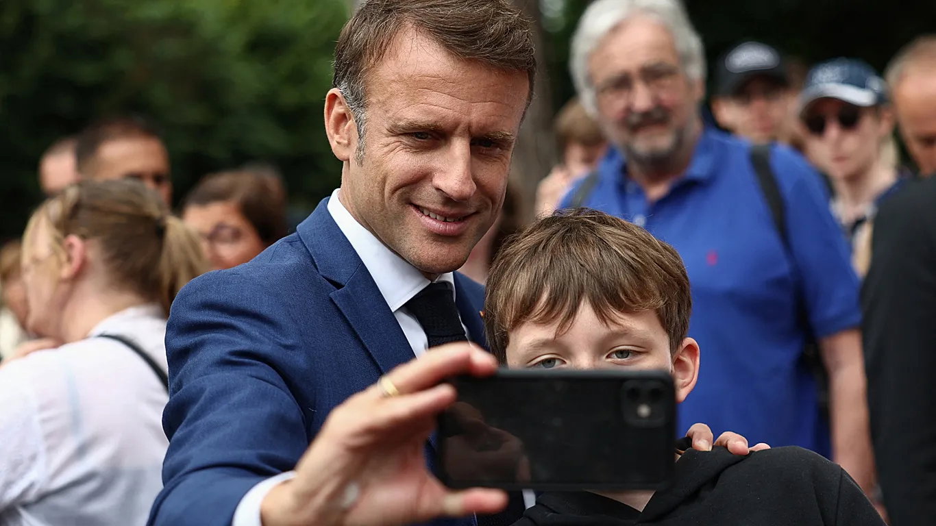 TechDogs-"An Image Of French President Emmanuel Macron Clicking A Selfie With A Child"