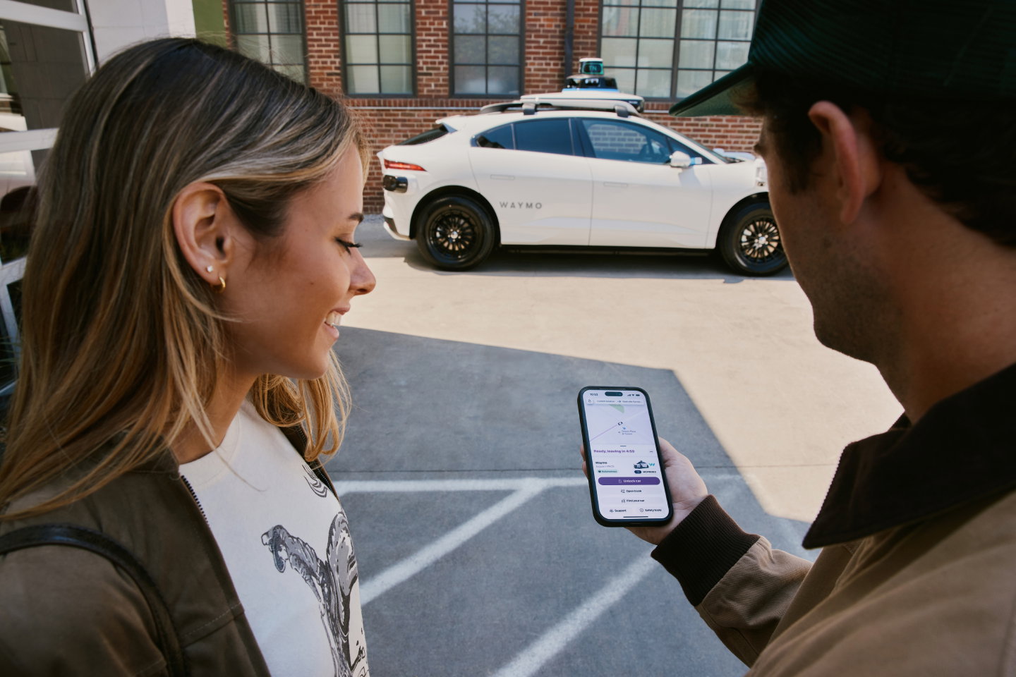 TechDogs-"An Image Depicting A Couple Booking A Waymo Robotaxi Through The Lyft App"