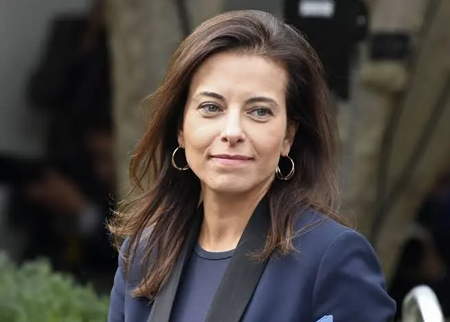 TechDogs-"Dina Powell McCormick smiling outdoors, wearing a navy blazer and gold hoop earrings." TechDogs-"Dina Powell McCormick smiling outdoors, wearing a navy blazer and gold hoop earrings."