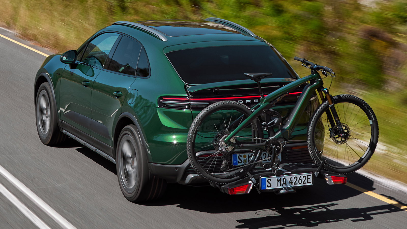 TechDogs-"An Image Of Porsche E-Bike Behind A Porsche Macan" TechDogs-"An Image Of Porsche E-Bike Behind A Porsche Macan"