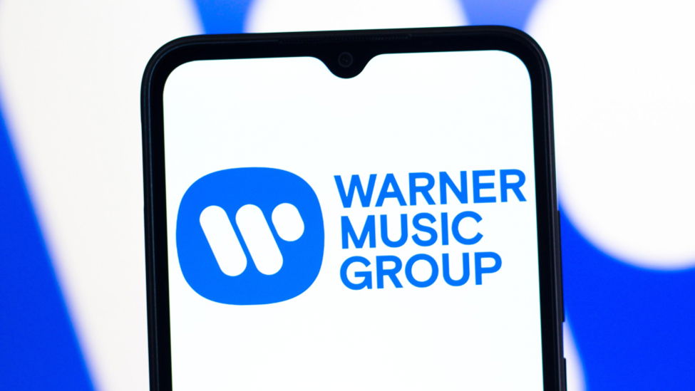 TechDogs - "An Image Showing The Warner Music Group Logo On A Smartphone"